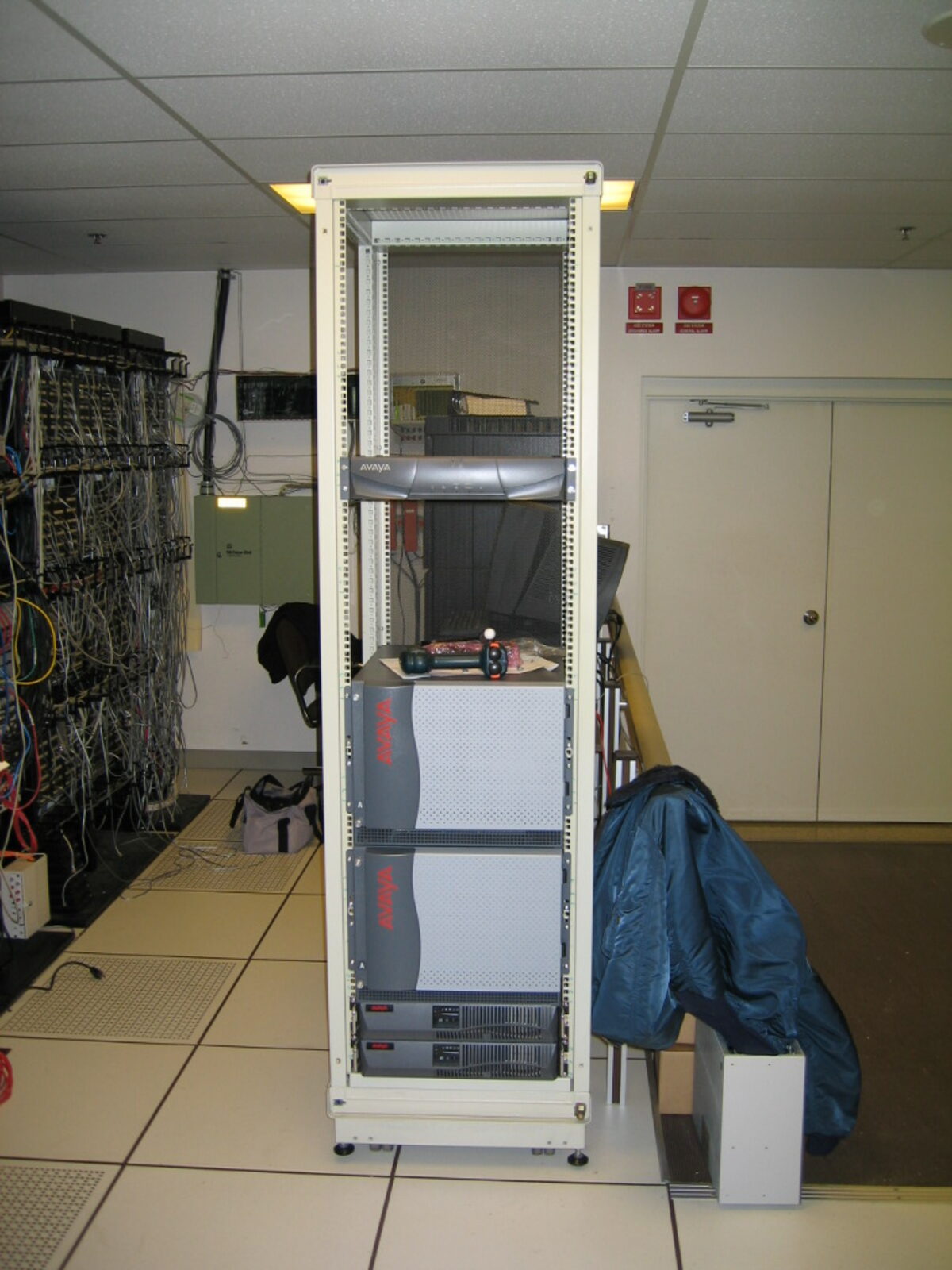 A new equipment rack being set up on the raised floor of a server room